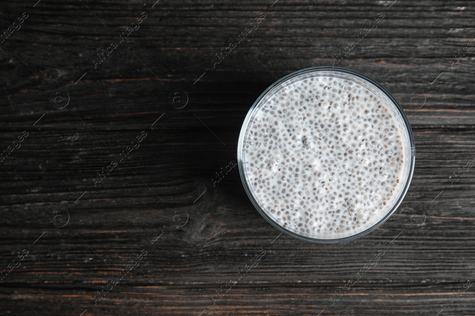 Photo of Dessert bowl of tasty chia seed pudding on table, top view. Space for text