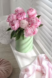 Photo of Bouquet of beautiful peonies on window sill