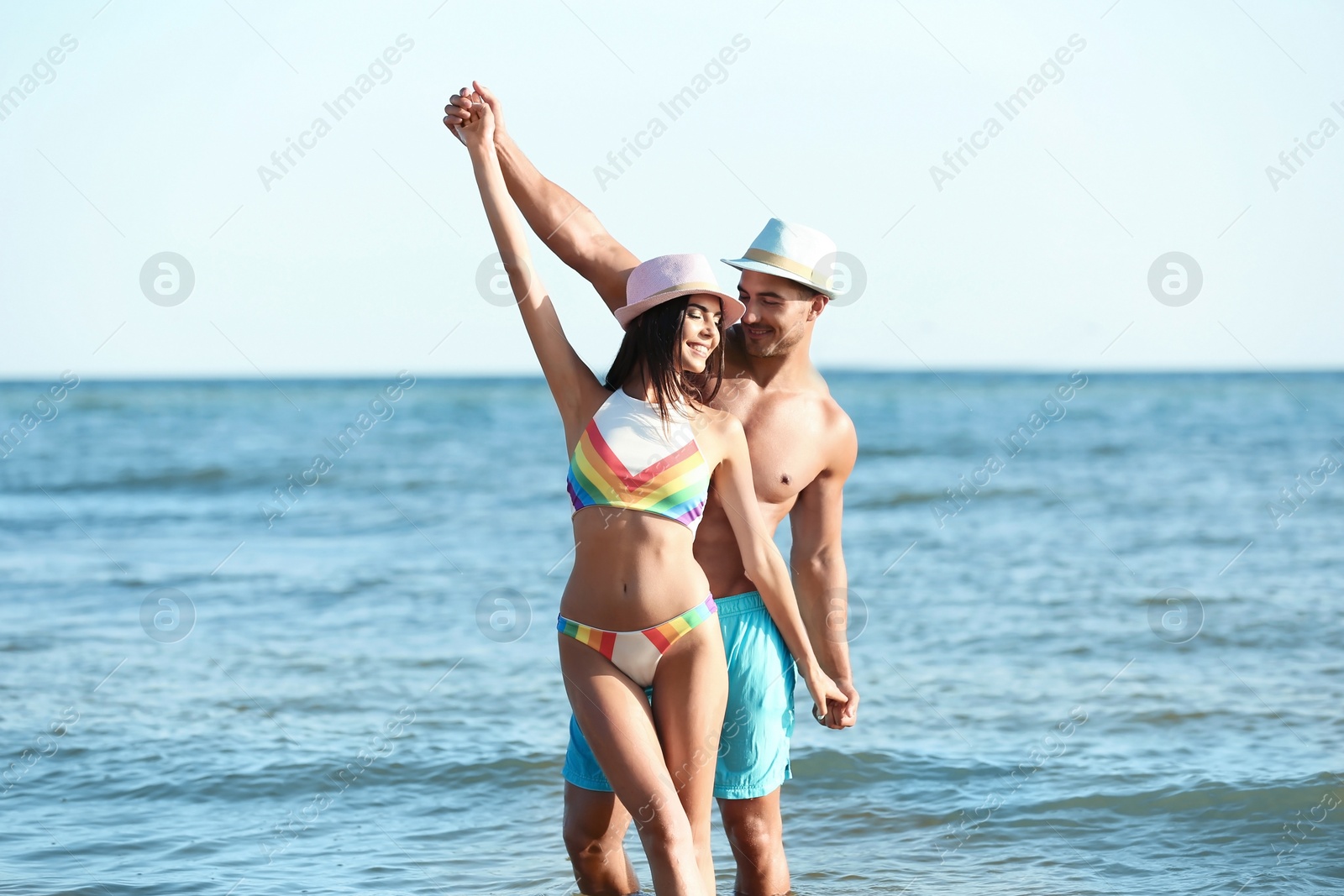 Photo of Happy young couple having fun at beach on sunny day