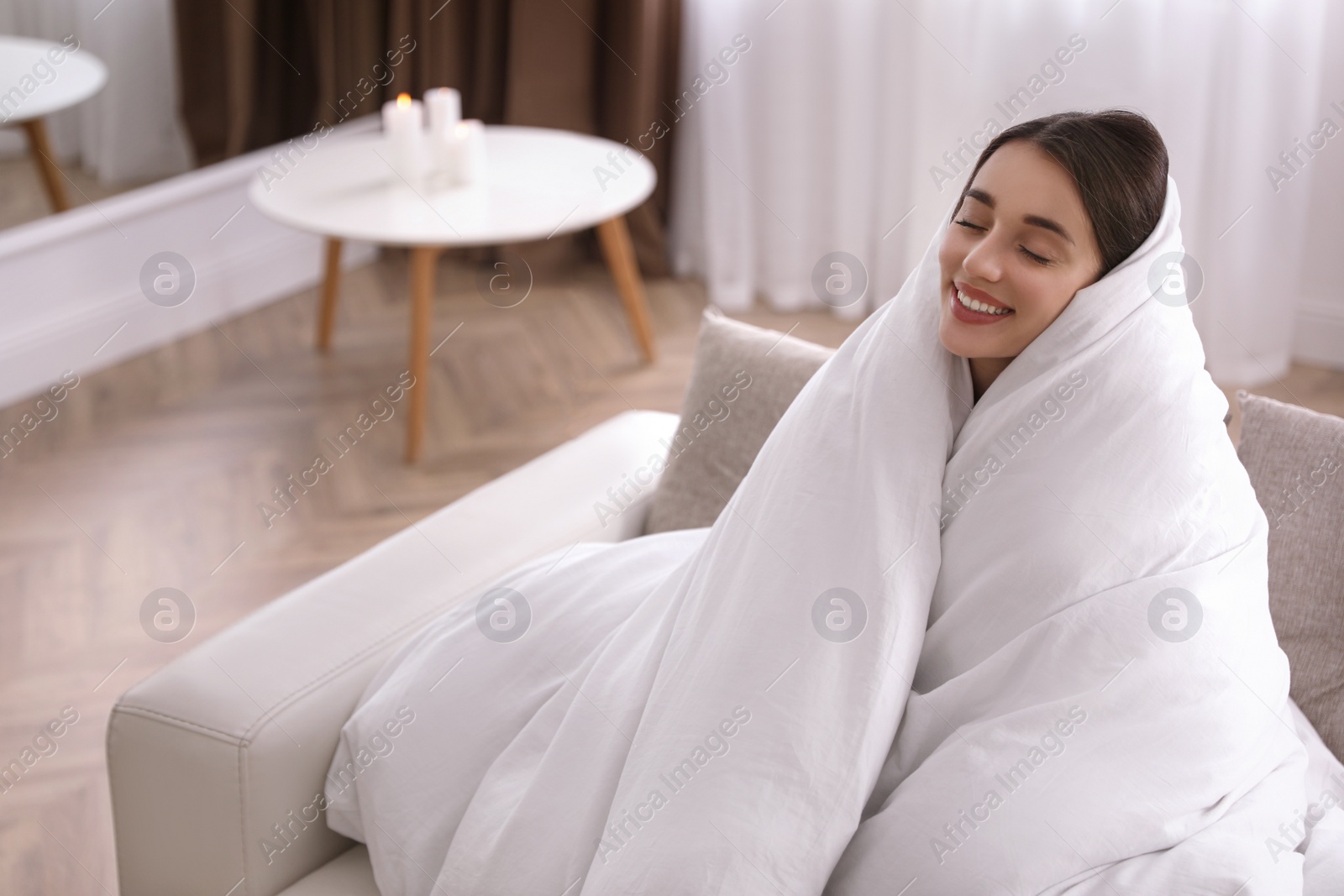 Photo of Woman wrapped in blanket resting on sofa, space for text