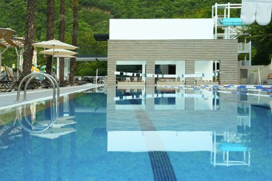 Photo of Outdoor swimming pool at luxury resort on sunny day