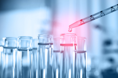 Dripping reagent into test tube, closeup. Laboratory analysis