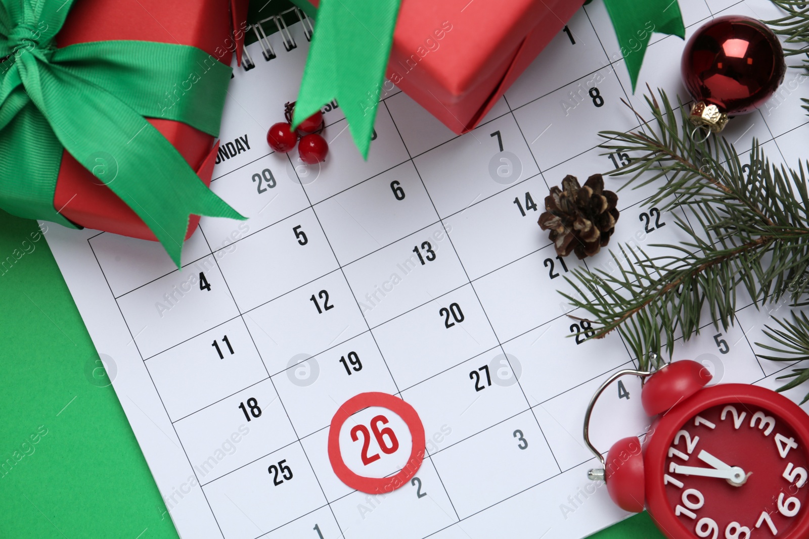 Photo of Flat lay composition with calendar on green background. Boxing day concept