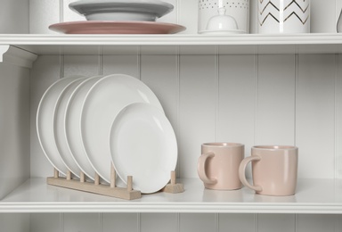 White shelving unit with set of dishware