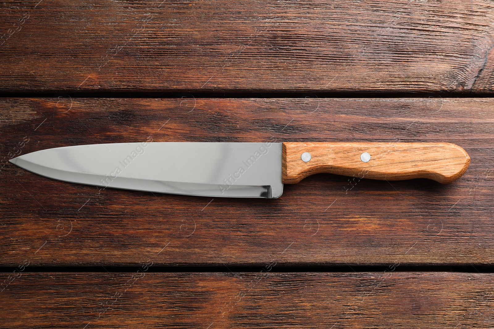 Photo of One sharp knife on wooden table, top view