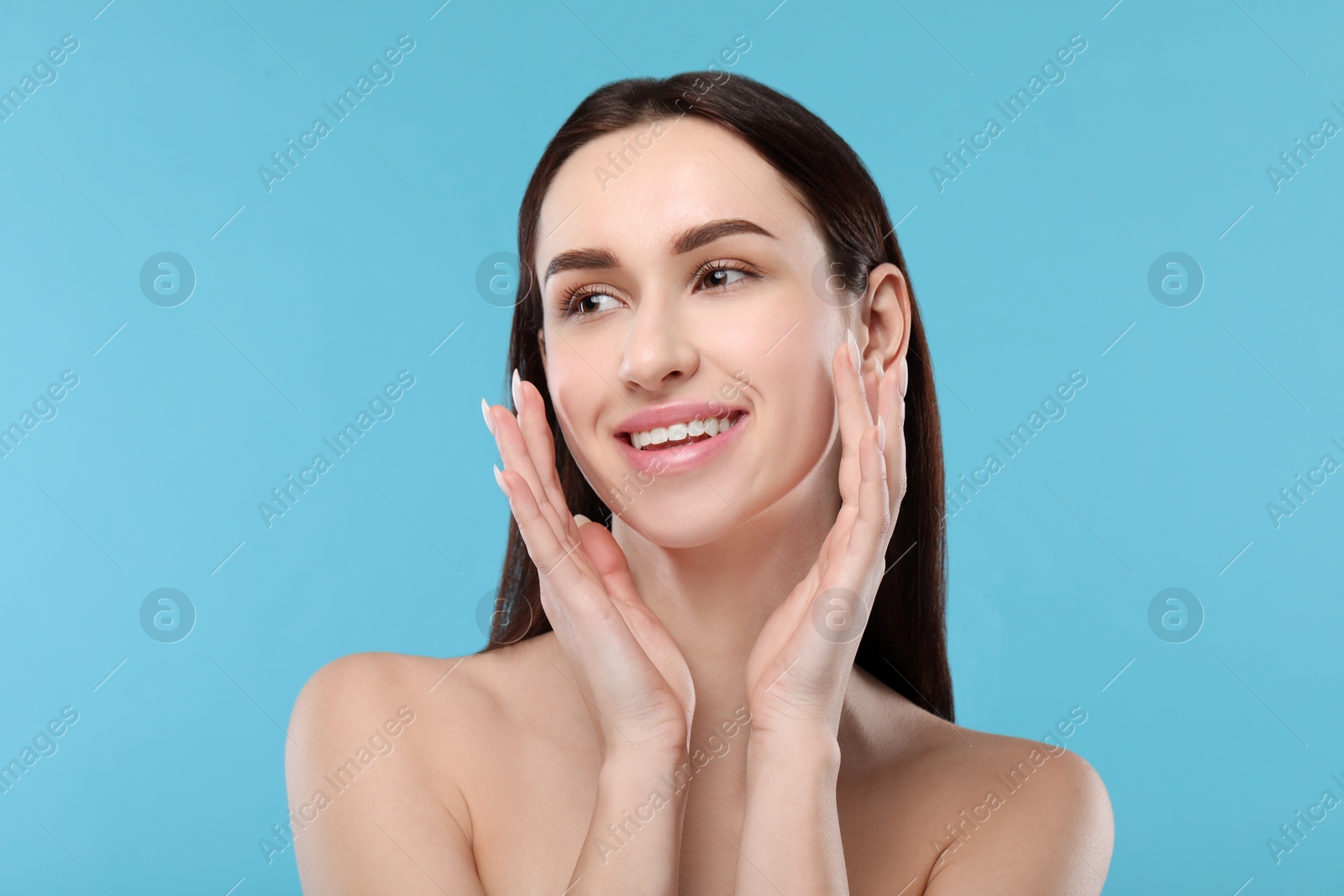 Photo of Portrait of beautiful young woman on light blue background