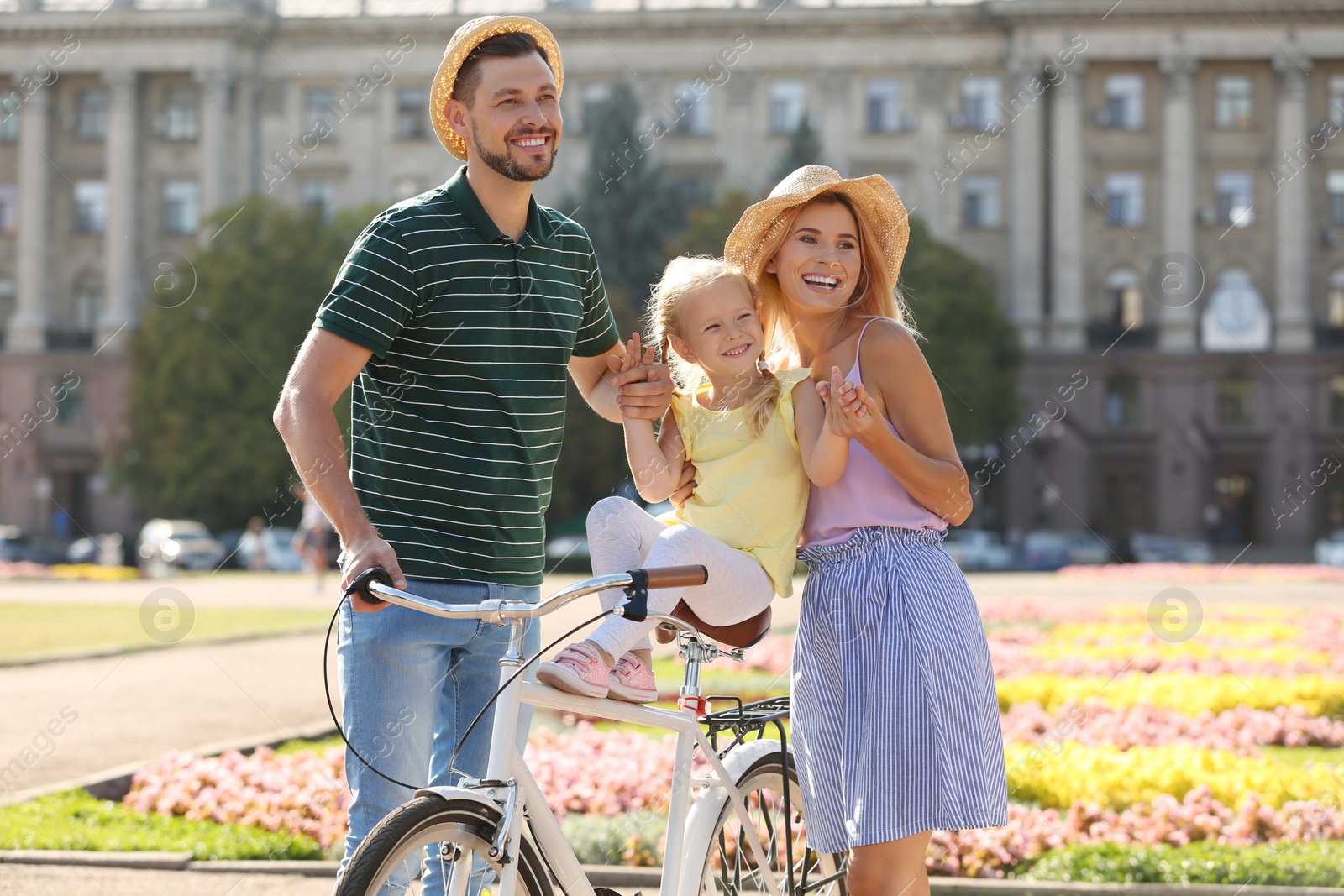 Photo of Happy family with bicycle outdoors on summer day