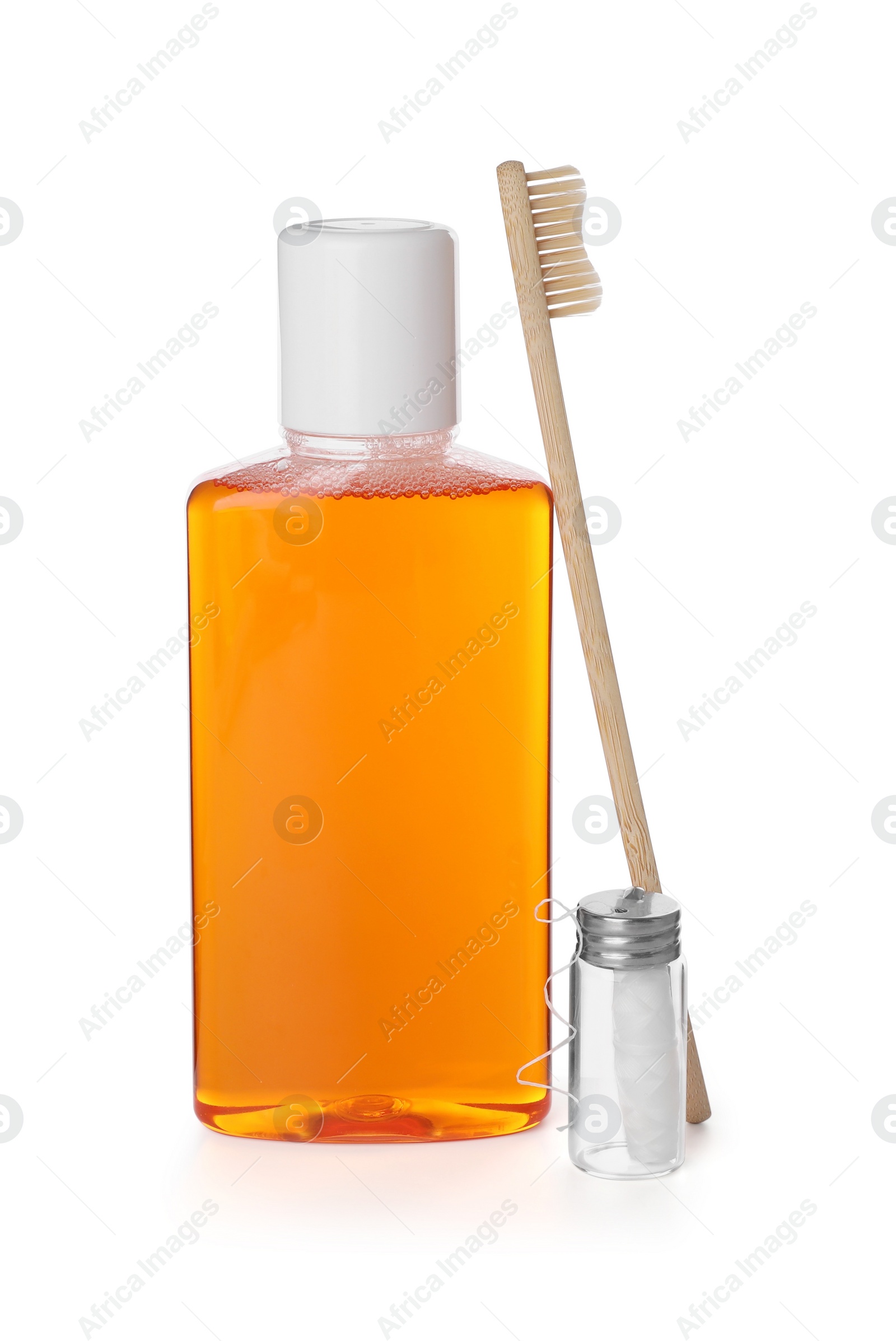 Photo of Mouthwash, toothbrush and dental floss isolated on white