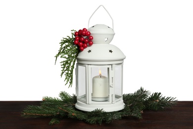Photo of Christmas lantern decorated with coniferous twigs and berries on grey background