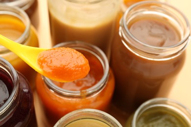 Photo of Eating healthy baby food at table, closeup. Space for text
