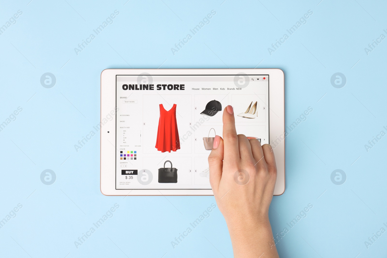 Photo of Woman with tablet shopping online on light blue background, top view