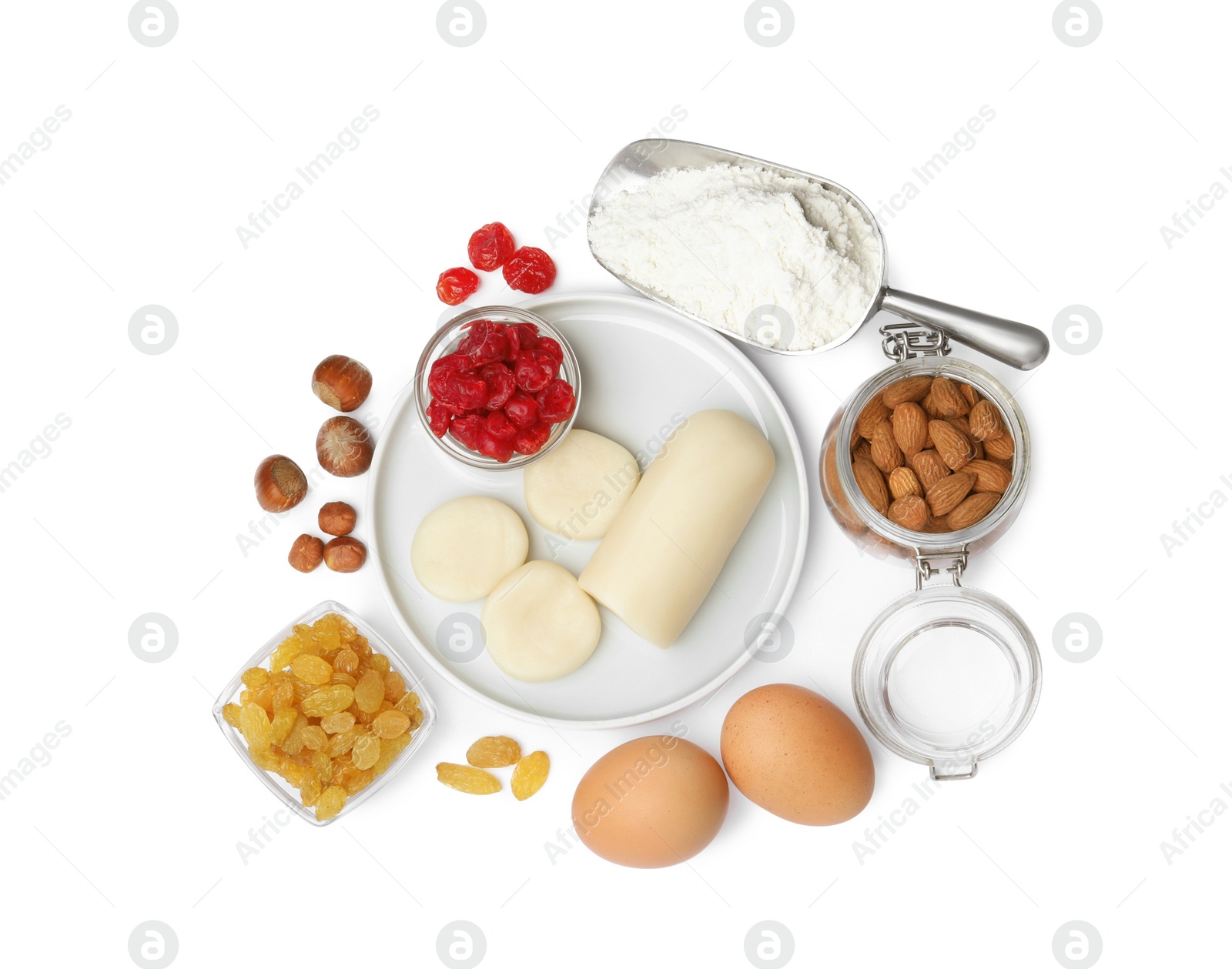 Photo of Marzipan and other ingredients for homemade Stollen on white background, top view. Baking traditional German Christmas bread