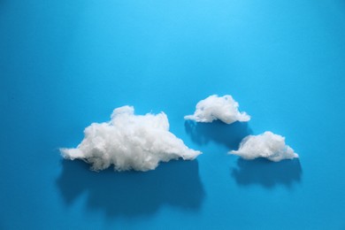 Photo of Clouds made of cotton on blue background. Space for text