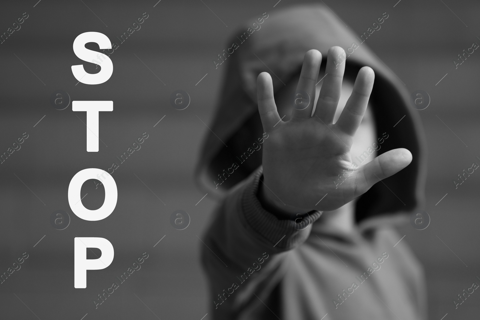 Image of No child abuse. Boy making stop gesture, selective focus. Black and white effect