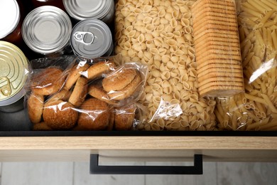 Photo of Open drawer with different products, top view. Food donation