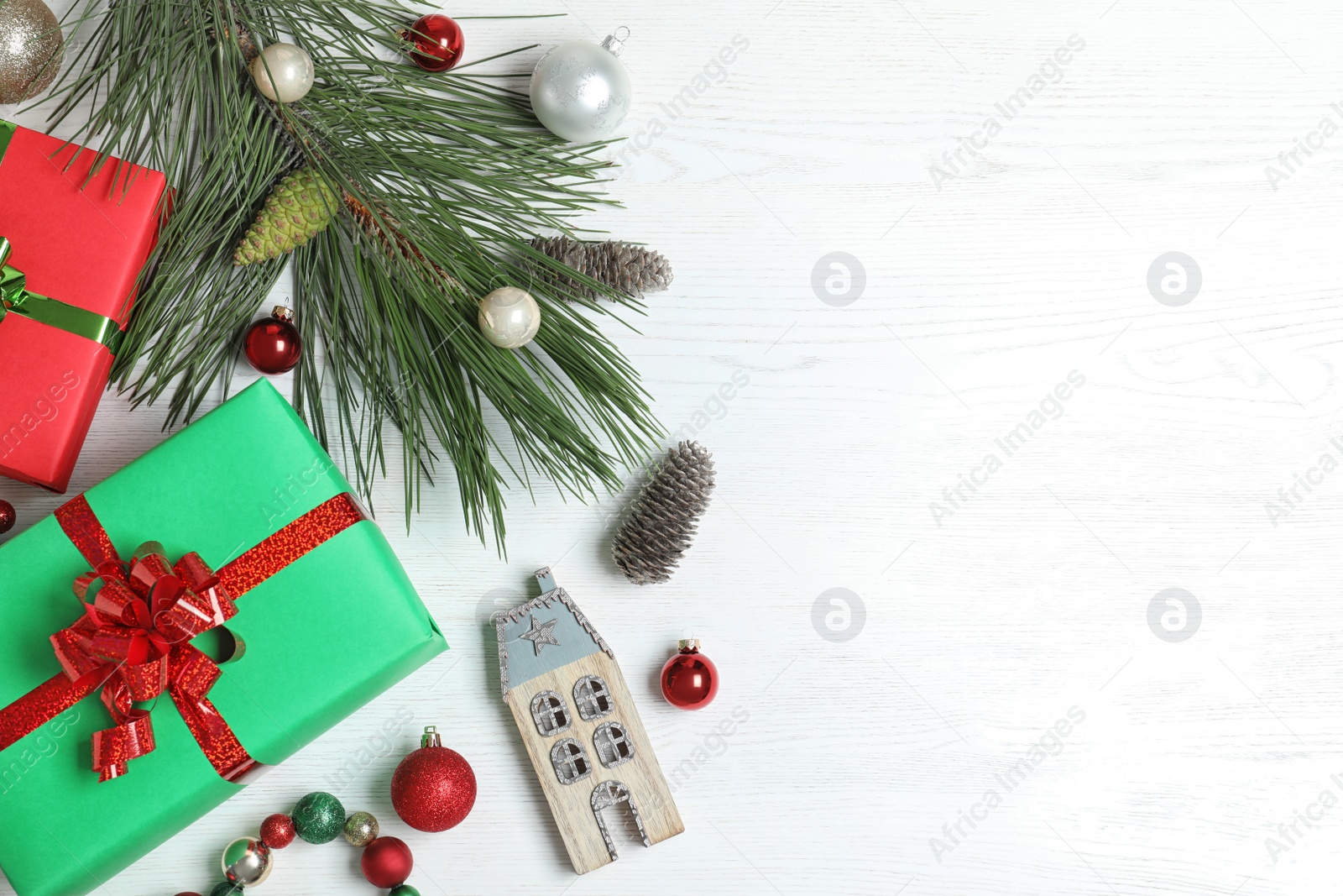 Photo of Flat lay composition with Christmas gift boxes on white wooden background. Space for text