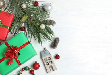 Photo of Flat lay composition with Christmas gift boxes on white wooden background. Space for text