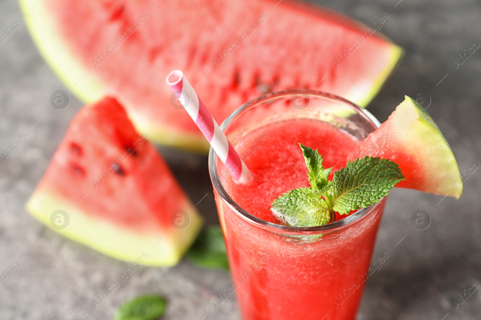 Photo of Tasty summer watermelon drink in glass on table, closeup