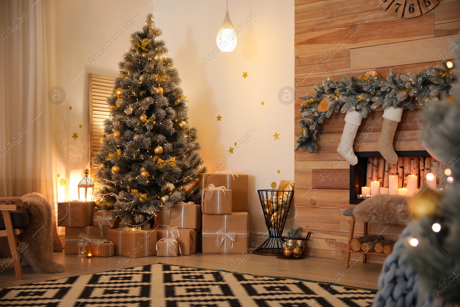 Photo of Stylish room interior with beautiful Christmas tree and decorative fireplace