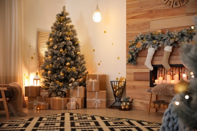 Photo of Stylish room interior with beautiful Christmas tree and decorative fireplace