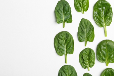 Photo of Fresh leaves of spinach isolated on white, top view