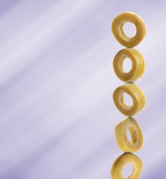 Image of Stacked slices of green olive on light purple gradient background, space for text