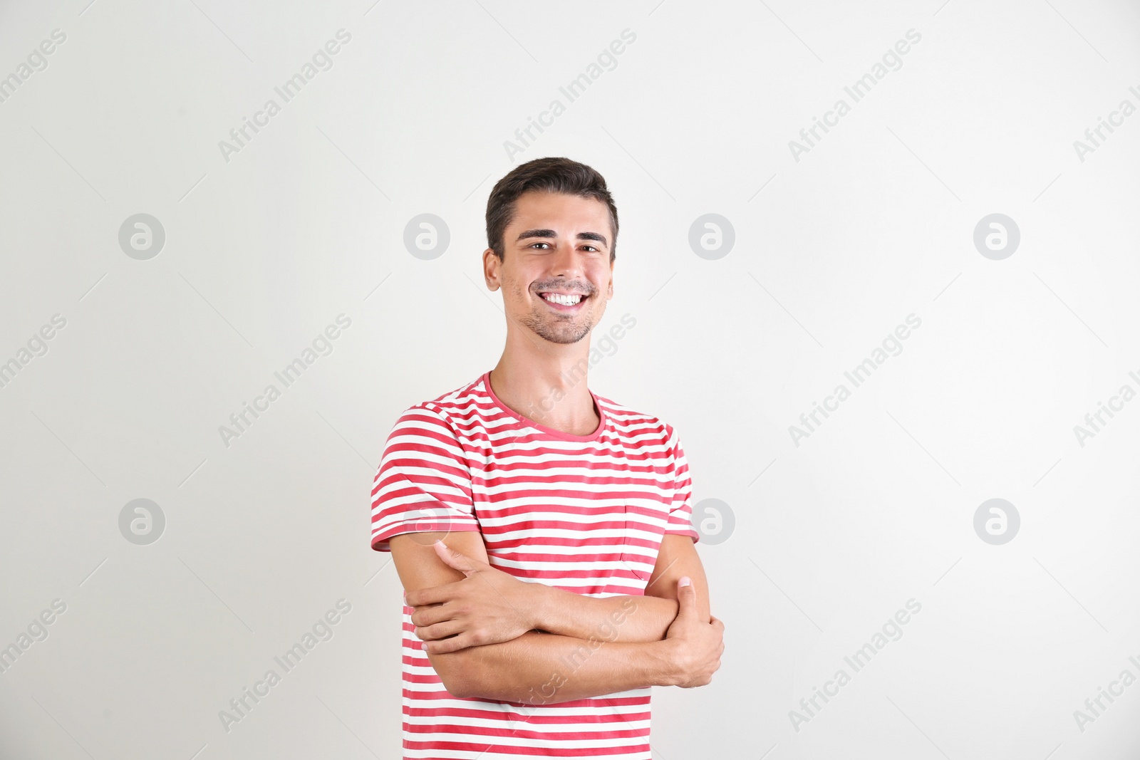 Photo of Portrait of handsome young man smiling on white background