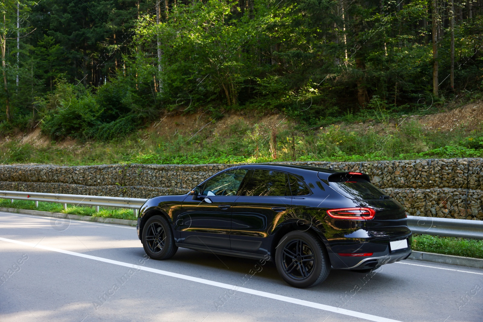 Photo of Picturesque view of asphalt road with modern black car