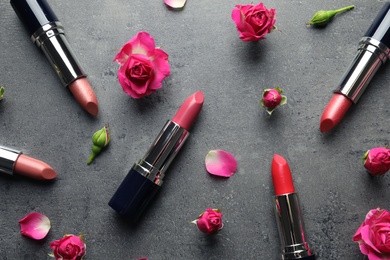 Photo of Flat lay composition with lipsticks and roses on grey background