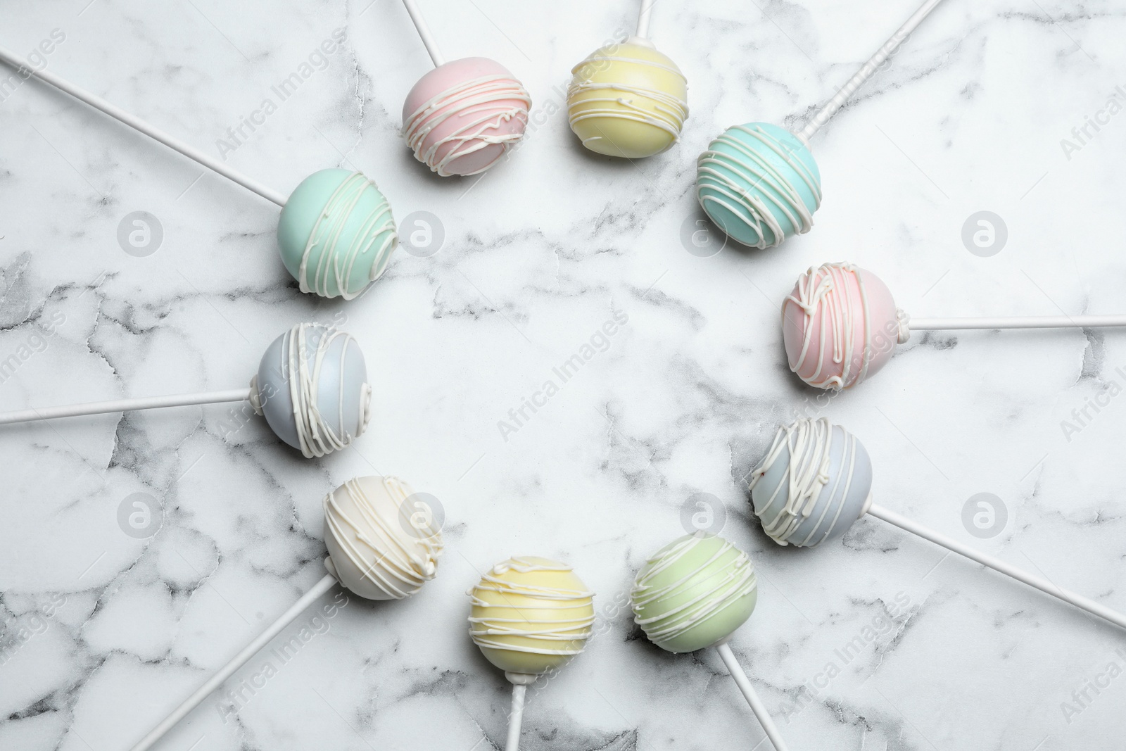 Photo of Sweet colorful cake pops on white background, flat lay. Space for text