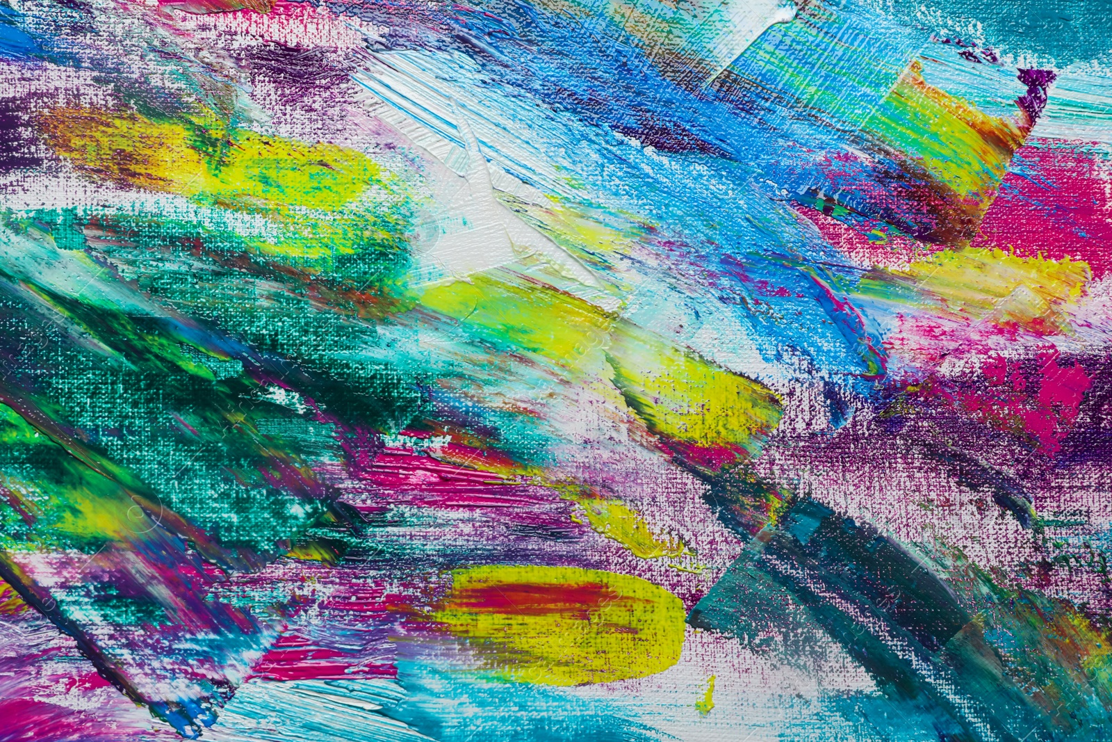 Photo of Strokes of colorful acrylic paints on canvas, closeup