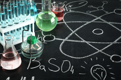 Photo of Composition with laboratory equipment on chalkboard. Chemistry concept