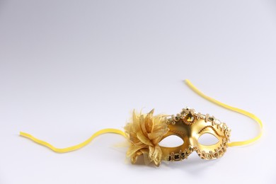 Photo of Beautifully decorated face mask on white background, space for text. Theatrical performance