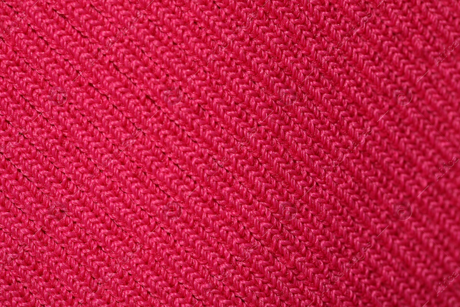 Photo of Texture of soft red knitted fabric as background, top view