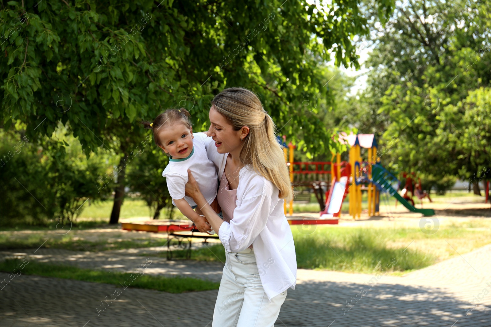 Photo of Happy mother with her daughter having fun in park