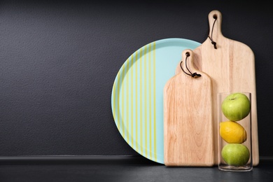 Composition with kitchenware and fruits on table against grey background. Space for text