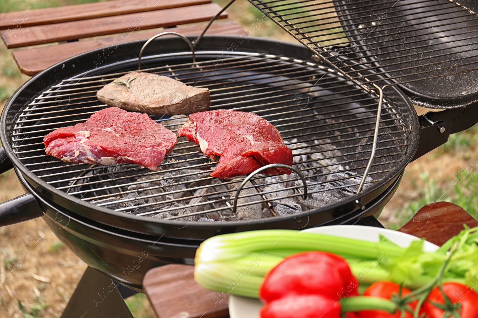 Photo of Tasty meat on barbecue grill outdoors, closeup