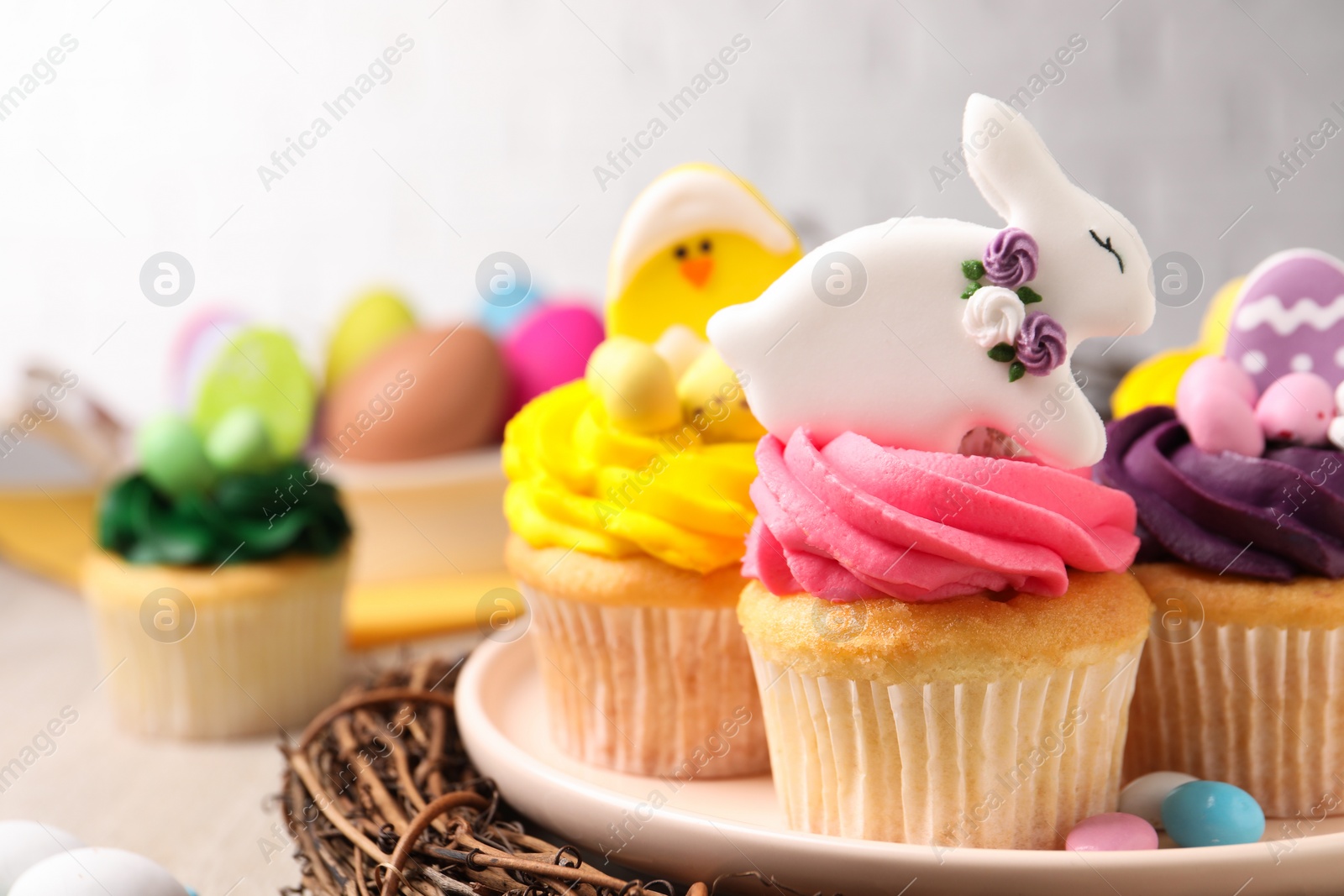 Photo of Tasty cupcakes with Easter decor on table