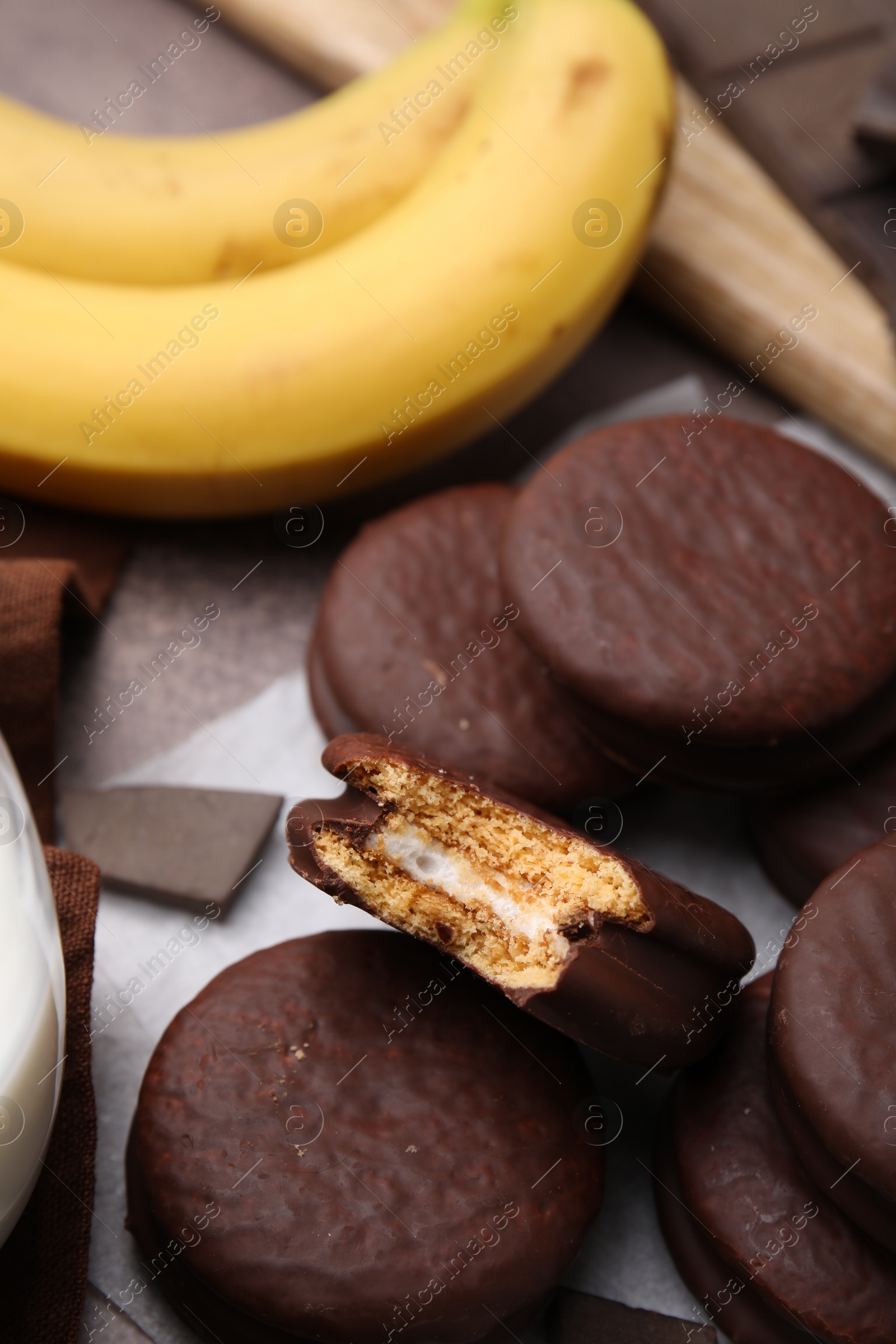 Photo of Tasty banana choco pies on table, closeup