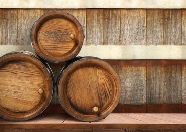 Image of Barrels on wooden background, space for text