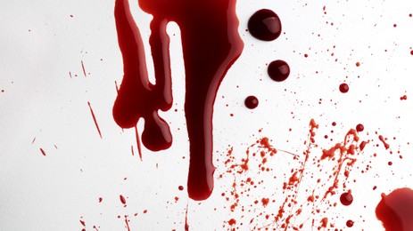 Photo of Stain and splashes of blood on light grey background