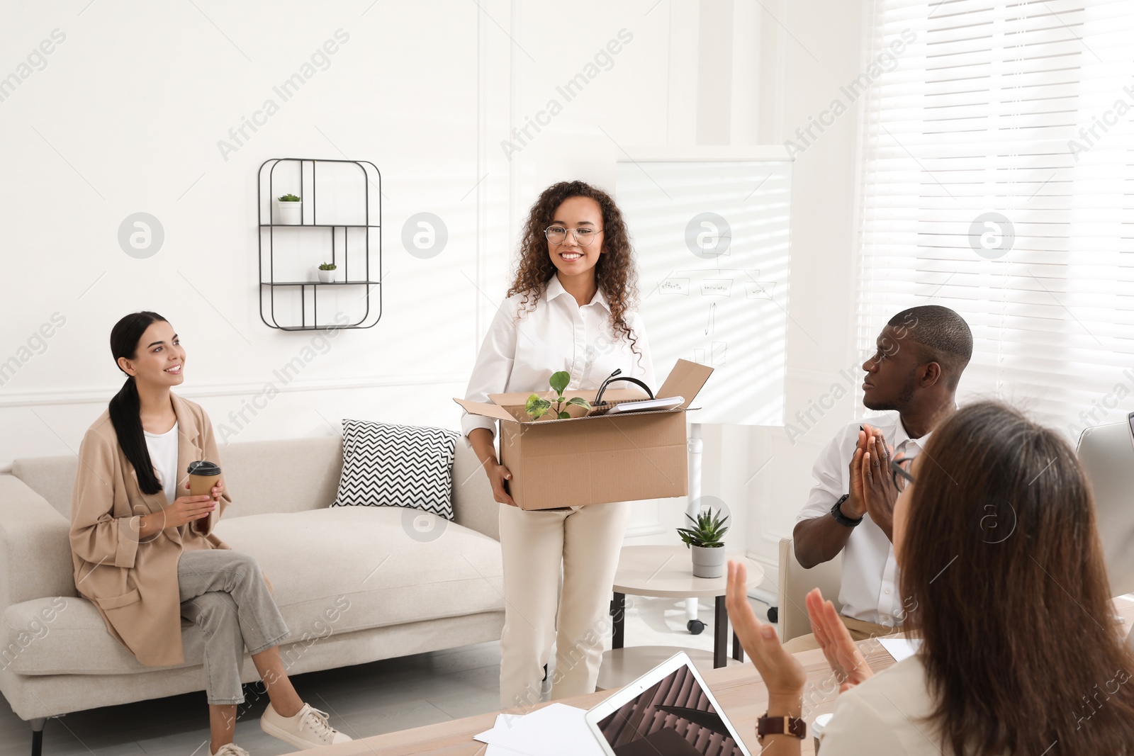 Photo of Group of coworkers welcoming new employee in office