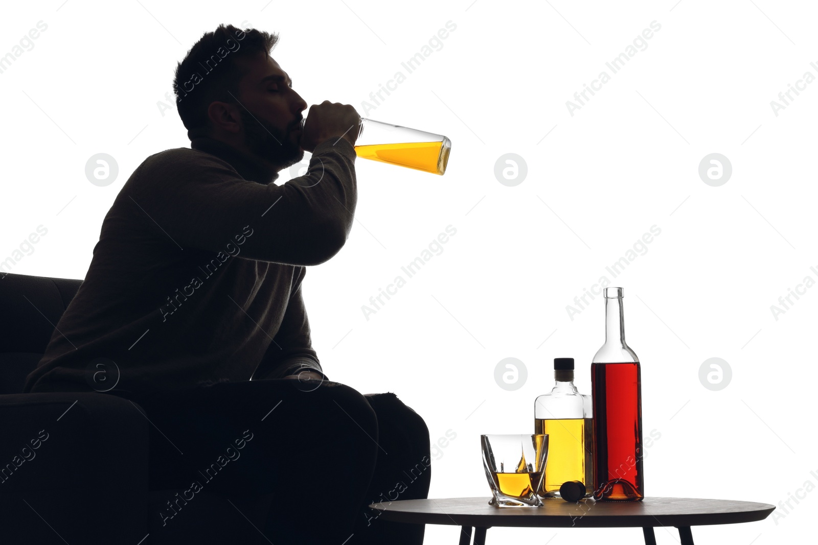 Photo of Silhouette of addicted man drinking alcohol on white background