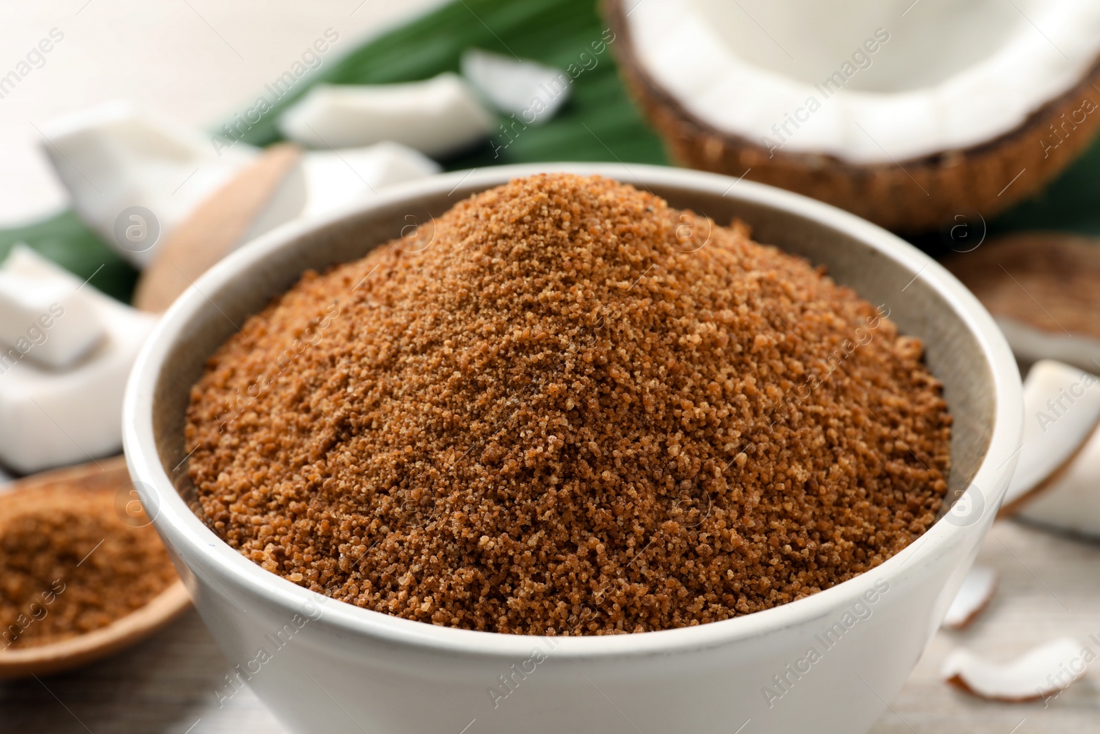 Photo of Natural coconut sugar in ceramic bowl, closeup