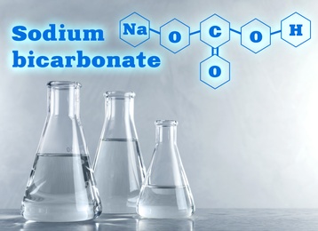 Text Sodium bicarbonate with soda formula and laboratory glassware on background