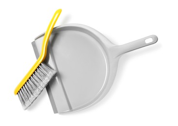 Plastic hand broom and dustpan on white background, top view