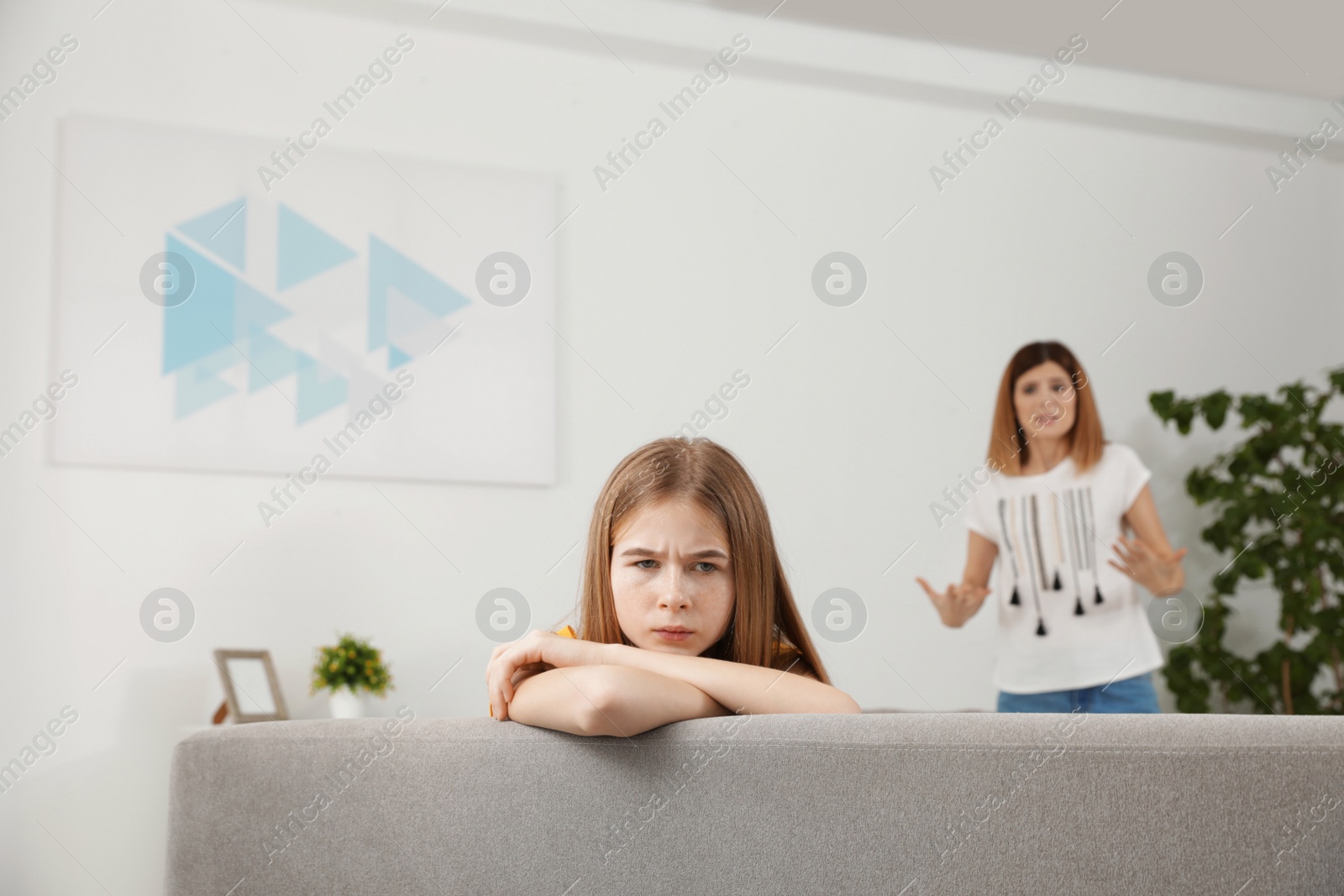 Photo of Mother scolding her teenager daughter at home