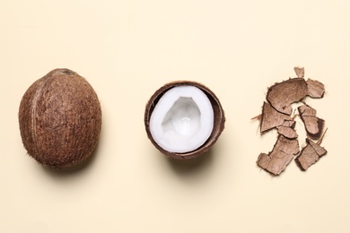 Photo of Flat lay composition with coconuts on beige background