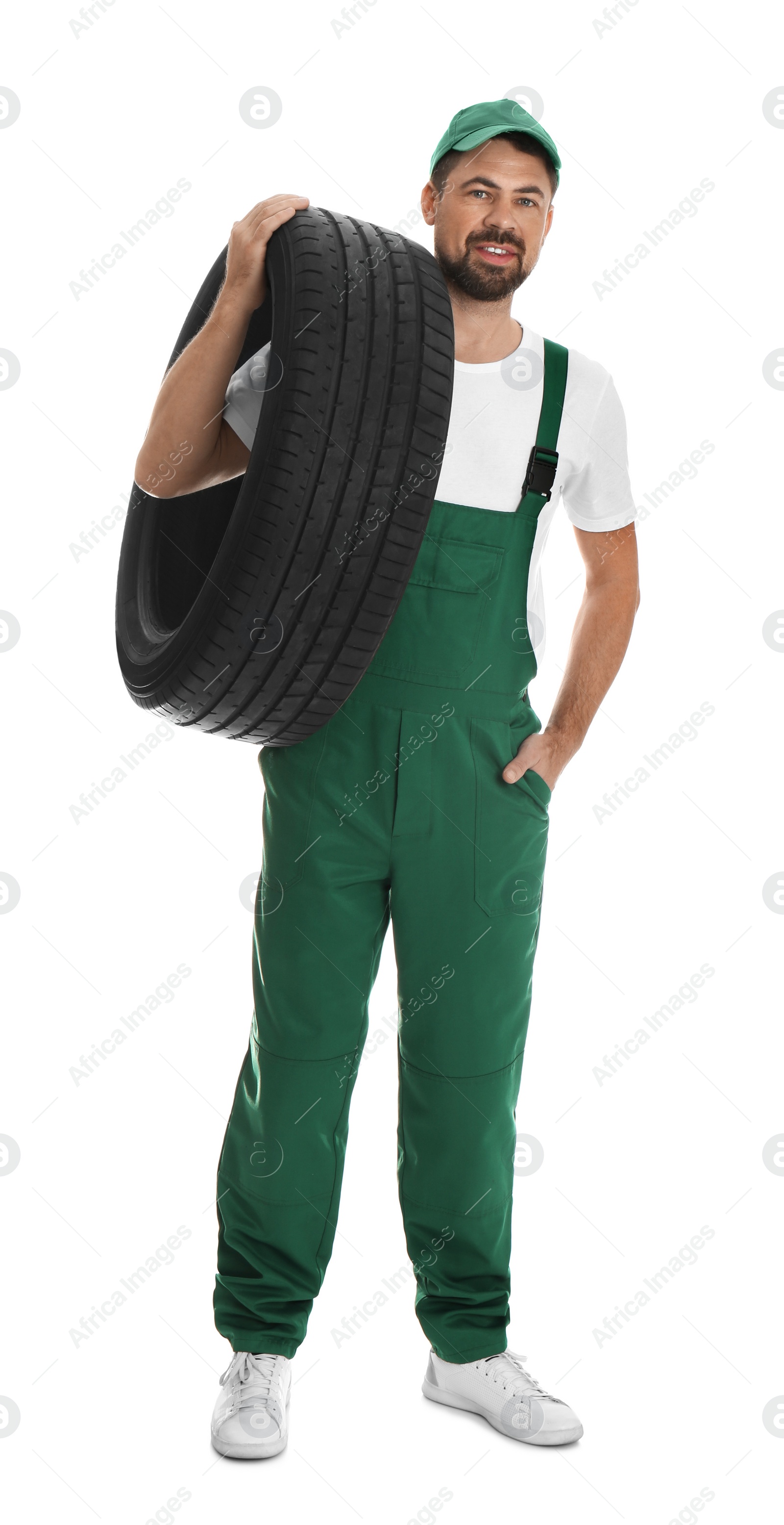 Photo of Full length portrait of professional auto mechanic with tire on white background