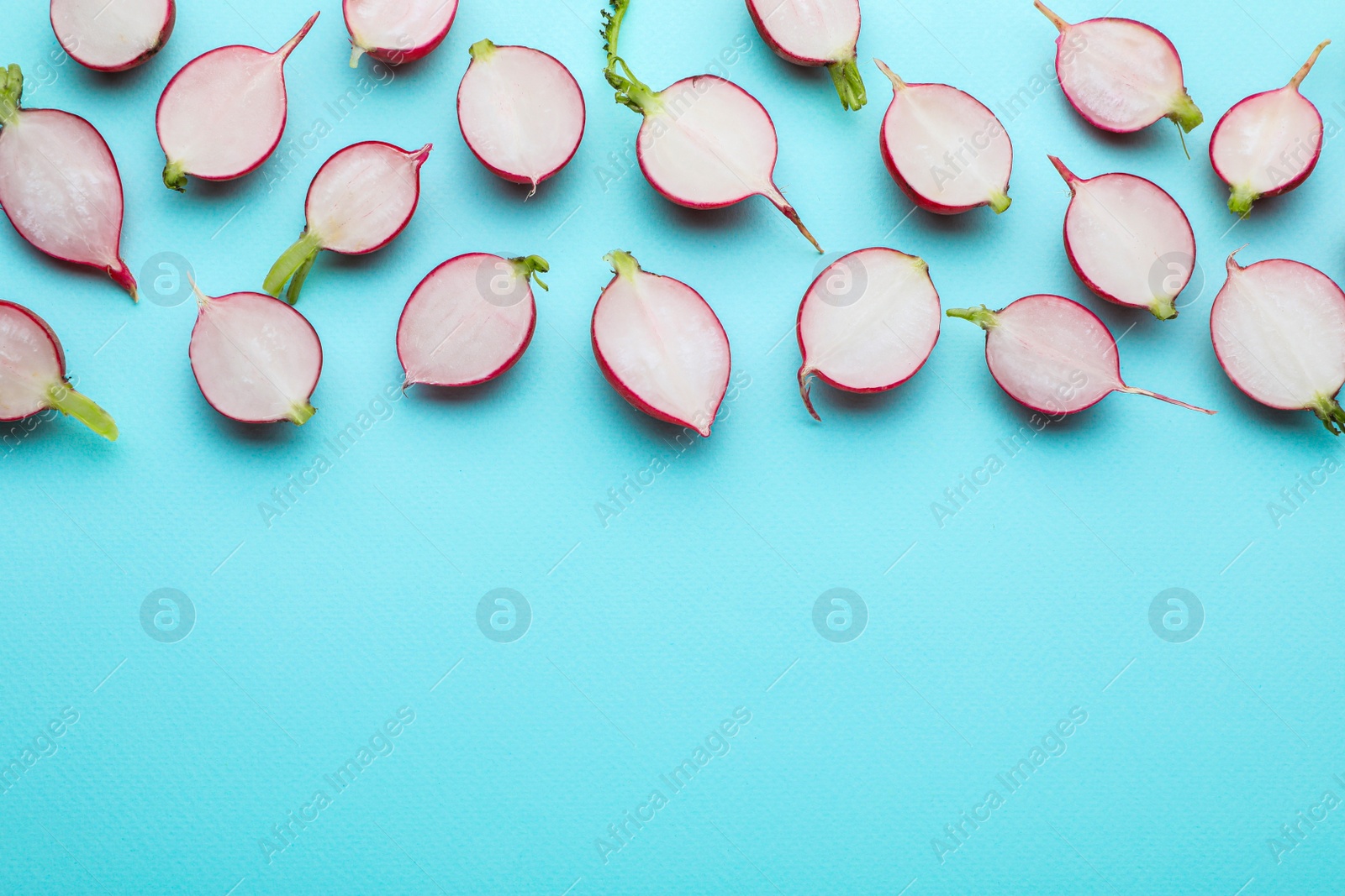 Photo of Fresh ripe radish on light blue background, flat lay. Space for text